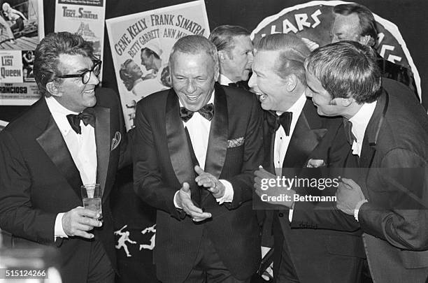 Las Vegas, NV- Frank Sinatra claps his hands as he is congratulated by Dean Martin, Milton Berle, and Rich LIttle after Sinatra received the first...