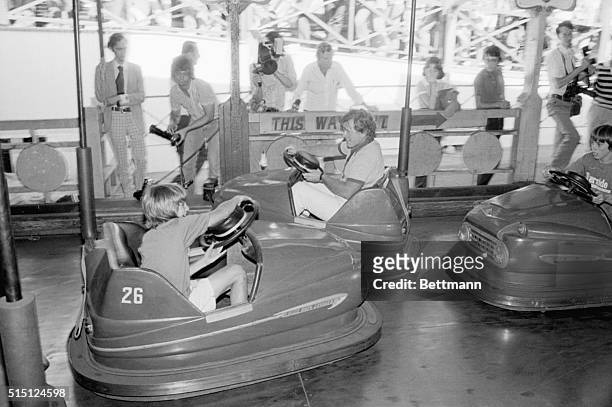 Agwam, MA- Senator Edward Kennedy is about to get bumped by his nephew Douglas Kennedy while riding the "dodge 'em" cars at Riverside Amusement Park...