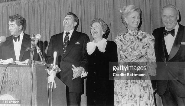 Boston, Massachusetts: Former California governor Ronald Reagan and his wife, Nancy enjoy a hearty laugh as Dean Martin quips at a press conference...