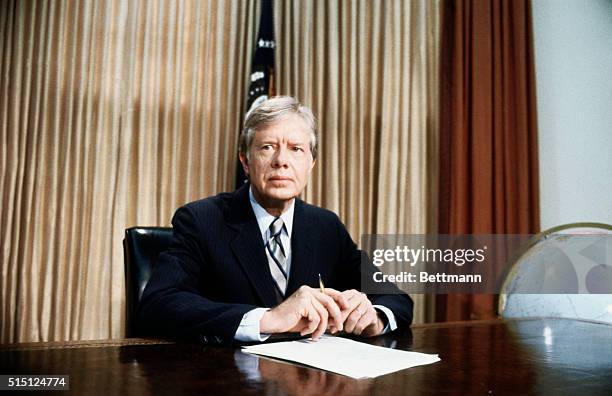 Washington, DC: A grim-faced President Jimmy Carter, seated at desk in Oval Office of White House tells of the aborted rescue effort intended to get...