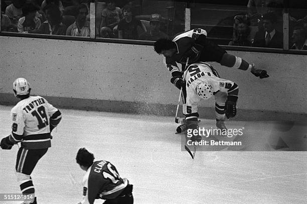Uniondale, New York: Denis Potvin of the Islanders checks the Flyer's Reggie Leach to the ice in the first period of game six of the Stanley Cup...
