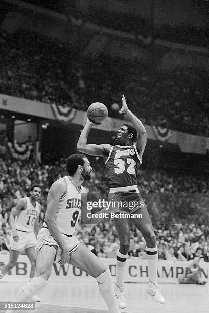 Lakers' Earvin Johnson cannot get control of the ball as he drives down the court in first period action with Sixers' Lionel Hollins defending in the...