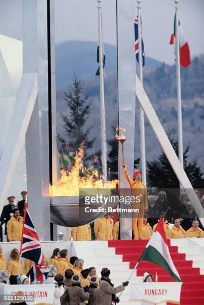 Dr. Charles Morgan Kerr holds his torch aloft after lighting the Olympic flame 2/13 during opening ceremonies for the 1980 Winter Olympic games.