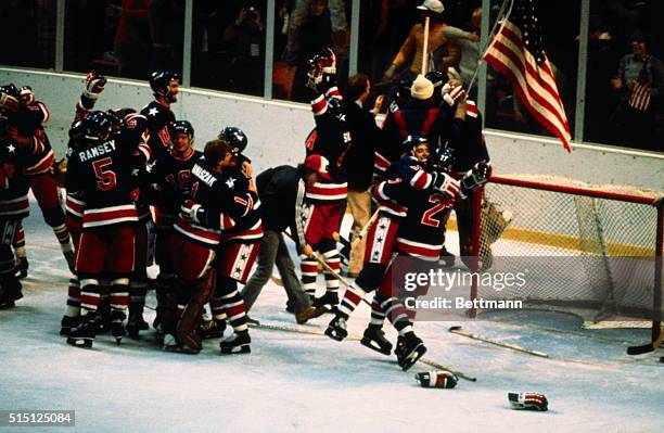 The American Olympic ice hockey team celebrates on the ice after defeating Finland, 4-2 in the final game, and winning the gold medal in the 1980...