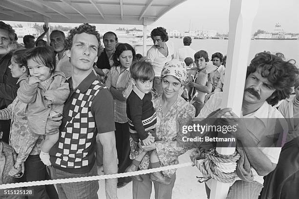 Key West, Florida: Members of a Cuban refugee family await their turn to depart from a boat which brought them from Havana, Cuba. The fishing boat,...