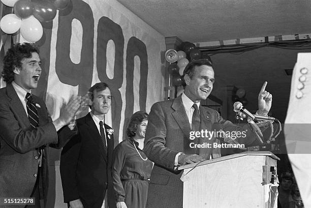 Concord, New Hampshire: Jeb Bush loudly applauds his dad, Republican presidential hopeful George Bush who tells his campaign workers he will battle...