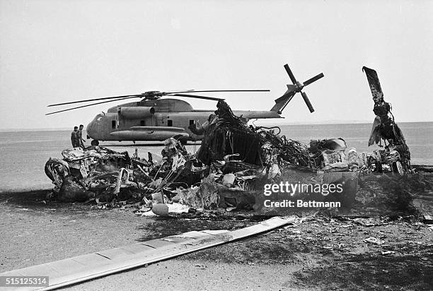 The wreckage of an American helicopter lies on the desert floor after an aborted attempt to rescue hostages from Tehran. The helicopter collided with...