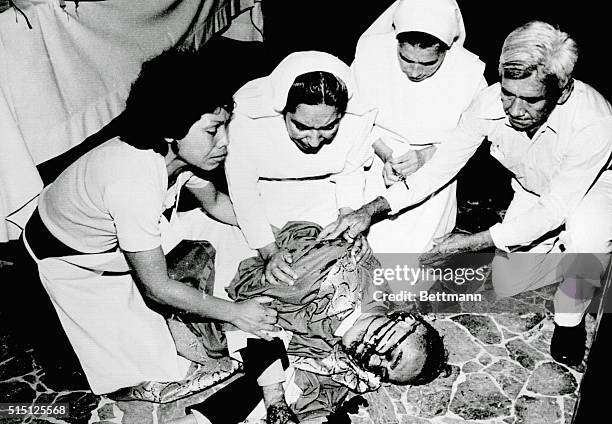 San Salvador: Nuns attend to the fallen Archbishop Oscar A. Romero minutes after he was assassinated by four gunmen as he said mass at the Divine...