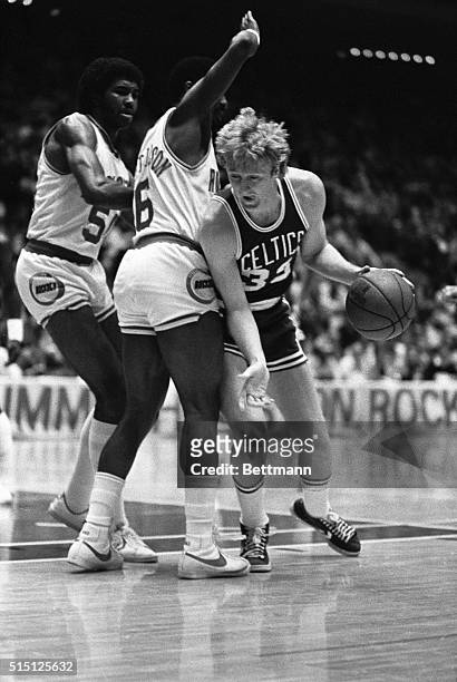 Boston Celtics' nominee for Rookie of the Year honors, Larry Bird , drives around Rockets guard Thomas Henderson in first half action at the Summit....
