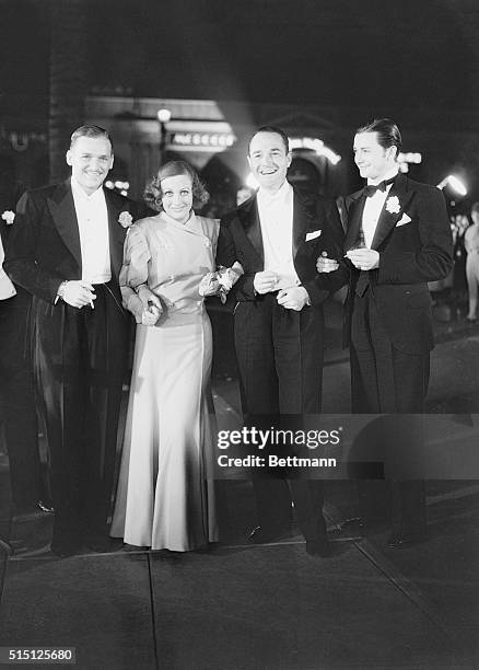 Hollywood, CA.: Douglas Fairbanks Jr., his wife, Joan Crawford, William Haines and Robert Young , are seen here as they arrived for the premiere of...