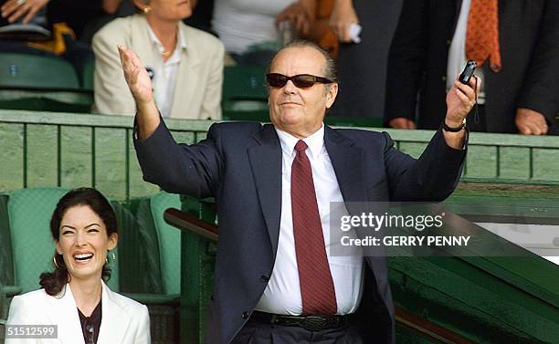 Actor Jack Nicholson, accompanied by US actress Lara Flyn Boyle, great the crowd before the Men's Single Final at Centre Court between Croatian Goran...