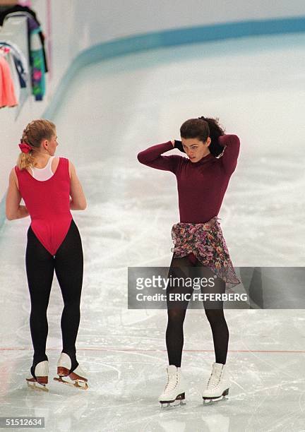 Tonya Harding of the United States stands next to compatriot Nancy Kerrigan during an early morning practice session 23 February 1994 in Hamar, near...
