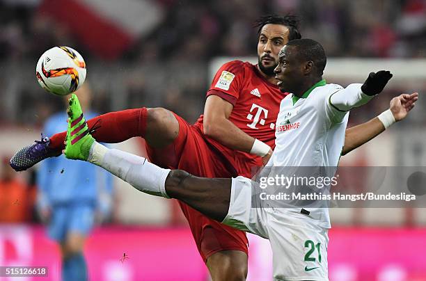 Anthony Ujah of Bremen is challenged by Medhi Benatia of Muenchen during the Bundesliga match between FC Bayern Muenchen and Werder Bremen at Allianz...