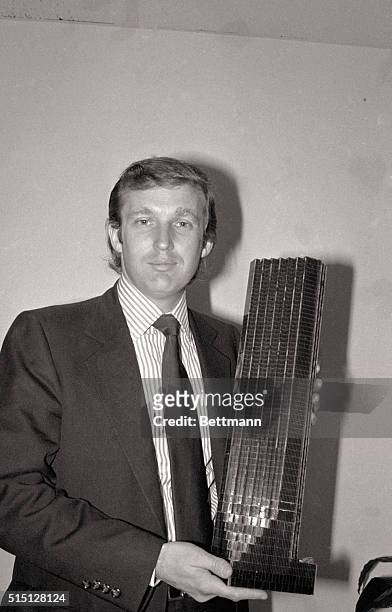 New York, NY- Donald Trump, 33-year-old golden boy of New York real estate, holds a model of the Fifth Avenue tower that will have shops, offices and...