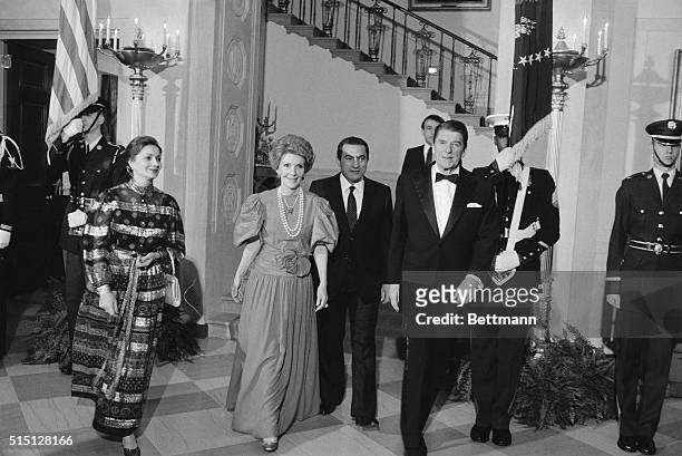 Washington: President and Mrs. Reagan escorts Egyptian President and Mrs. Hosni Mubarak to the State Dining Room for a State Dinner in their honor at...