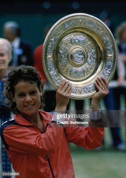 Wimbledon, London, England: Evonne Cawley holds aloft her trophy here, July 4, after defeating Chris Evert Lloyd in the Ladies' Singles Final, 6-1,...