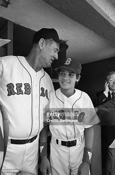 Ted Williams, former Red Sox great chats with his son John Henry Williams in the Red Sox dugout at Fenway Park. The Red Sox held their first ever Old...