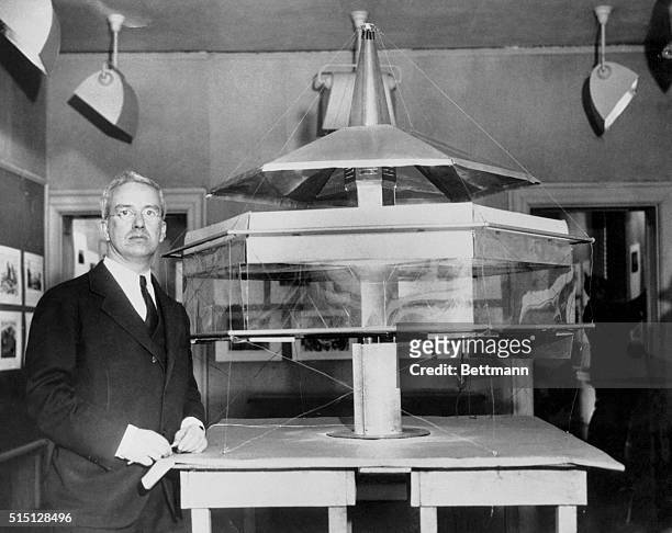 Architect Displays Dymaxion House. R. Buckminster Fuller, prominent New York architect, is seen here with a four foot model of his Dymaxion House, or...