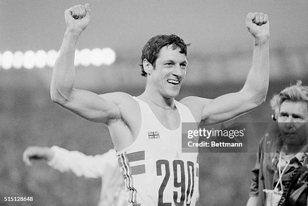 Allan Wells of Scotland raises his arms in victory as he wins the men's 100 meter sprint final for the gold medal 7/25 n a photo finish in time of...