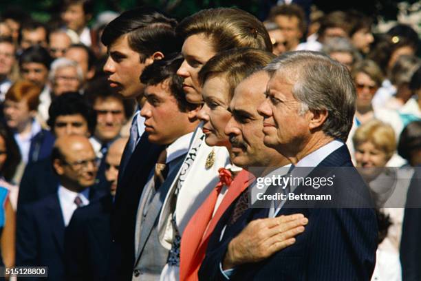 Queen Noor, King Hussein, and the Jordan princes, Abdullah and Faisal, join President Jimmy Carter and First Lady Rosalynn Carter at a White House...