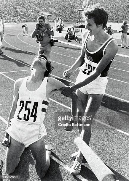 Britain Coe is exhausted on his knees and is helped by East Germany's Jurgen Straub after winning the 1500 meter final 8/1. Strab took the silver.