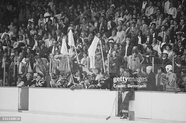 Vancouver Canucks coach Roger Neilson and two of his players wave white towels on sticks in protest to a bench penalty called against them during a...
