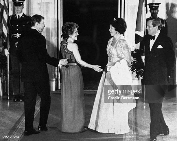 Washington, D.C.: President and Mrs. Reagan escort Queen Beatrix and Prince Claus of the Netherlands into the White House for a state dinner held in...
