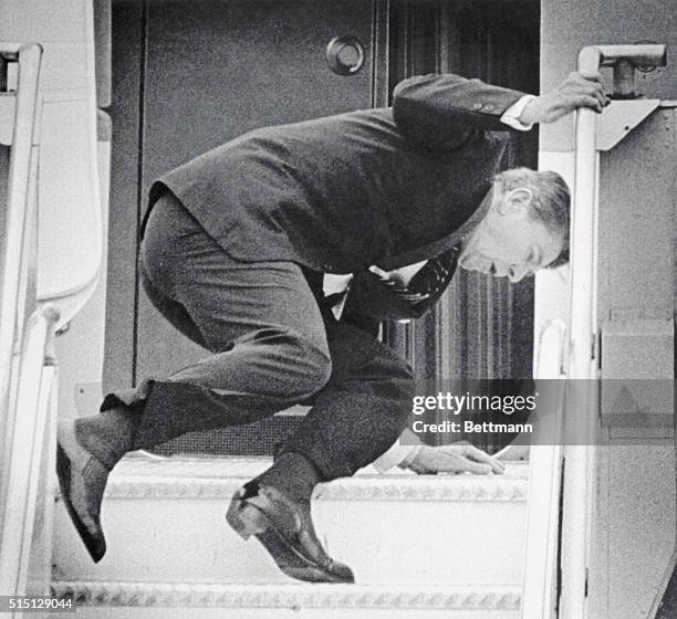 Seattle, Washington: President Reagan slips and falls to the deck of the stairway ramp to Air Force One as he was ascending the steps at King County...