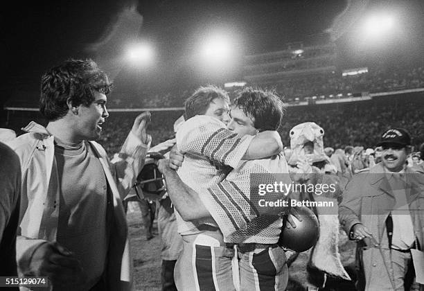 Boston College quarterback Doug Flutie hugs a teammate after beating the Hurricanes 47-45 in the final six seconds of the game.