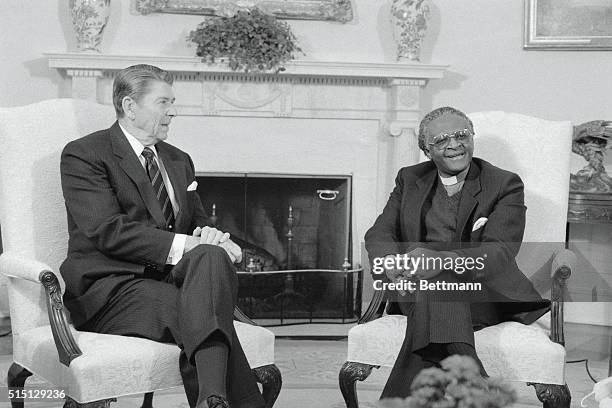 Washington, D.C.: President Reagan meets with Nobel Prize winning Bishop Desmond Tutu in the Oval Office. Tutu has denounced the Reagan...