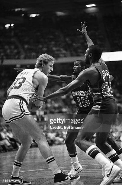 Celtics' Larry Bird is double-teamed by Milwaukee Bucks Craig Hodges (150 and Paul Pressey as Bird tries to pass ball off during 1st quarter action...