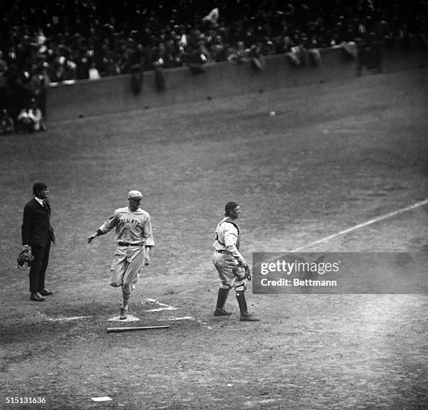 Kelly, Giant First Baseman, and MP is shown during the first run for the McGraw team in the first game of the 1923 World Series.