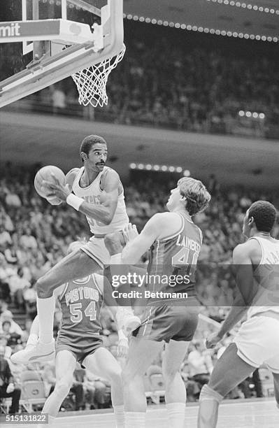 Houston: Rocket's power forward Ralph Sampson leaps into the air to pull down a rebound as the Pistons' center Bill Laimbeer looks on during first...