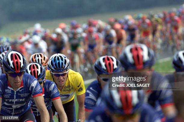 The yellow jersey, leader of the US Postal team, US Lance Armstrong rides among his teammates in the pack during the 19th stage of the 88th Tour de...