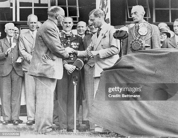 Presenting Ryder Cup Trophy. Southport, Merseyside, England, UK: J.H. Taylor , non-playing captain of the British Ryder Cup Team, receives from the...