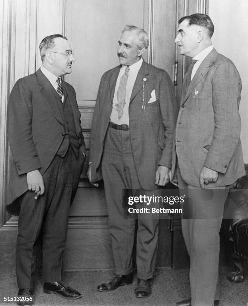 Left to right are shown Senator Fred Austin, Senator John Powers, and Lieutenant Governor Toupin of Rhode Island, in conference after the gas attack...