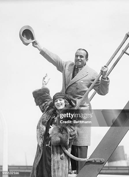 Actress Mary Pickford and her husband, actor Douglas Fairbanks, sail for a summer vacation. They were besieged by crowds and cameramen on the deck of...