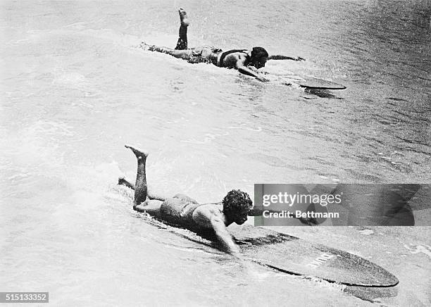 Here is shown a view of the recent surfboard swimming championships at Waikiki Beach, where Duke Kahanamoku, the champion in the event defended his...