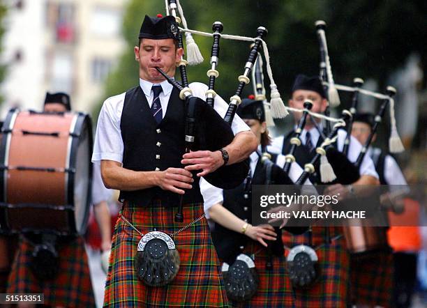 Scottish bagpipers march 05 August 2001 in Lorient, during the traditional grand street parade of the Interceltic Festival of Lorient which regroups...