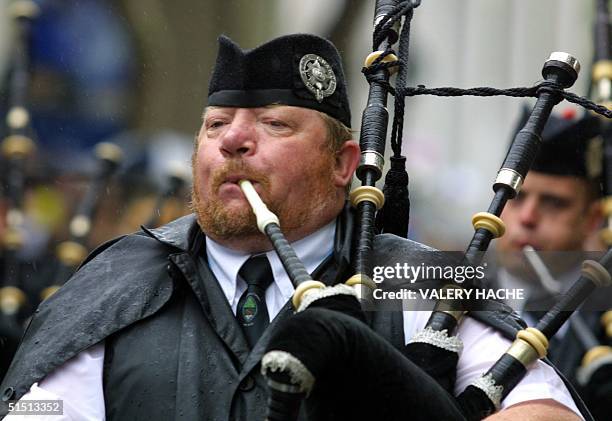 An Irish bagpiper marches 05 August 2001 in Lorient, during the traditional grand street parade of the Interceltic Festival of Lorient which regroups...