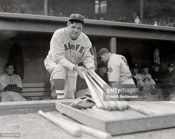George Herman "Babe" Ruth looks over the bats before going to bat for the Braves in their game against the Red Sox, in Boston, Massachusetts, April...