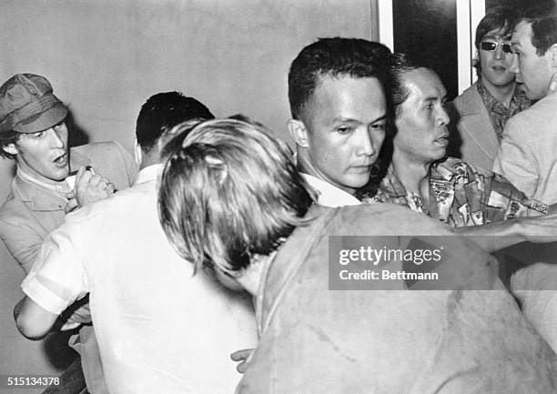 Manila: Manila Fans Kick Beatles. British famous Beatles, John Lennon , George Harrison , and Paul McCartney , look surprised at the Manila...