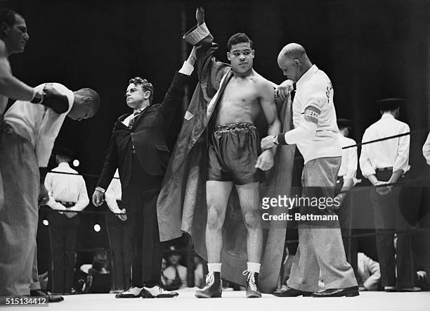 Joe Louis, heavyweight challenger, after he had been given a technical knockout over King Levinsky in their fight in Chicago. Hal Totten, announcer...