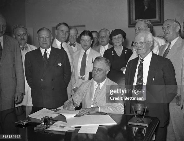 Fdr Flsa President Franklin Delano Roosevelt signs the Social Security Bill in ...