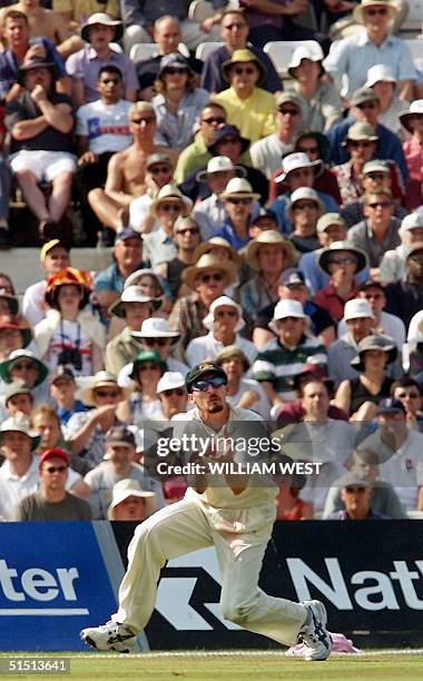 Australian fieldsman Jason Gillespie juggles a catch ton dismiss England batsman Usman Afzaal on the third day of the fifth Test Match at the Oval in...