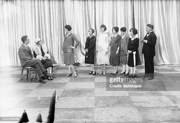 Line of girls, entered in the contest being held by the Broadway Association to select as 'Miss Broadway' as they appeared watching Judges Norman...