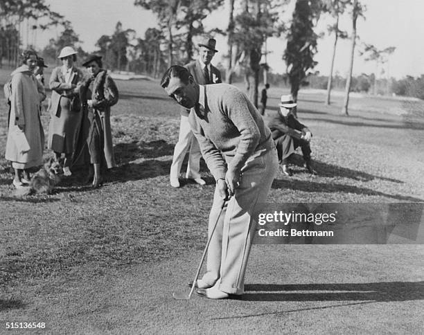 Orlando, Florida: Tony Manero, of Greensboro, North Carolina, sinking a putt on the 18th hole that gave him a 68, 3-under par, and low honors for the...