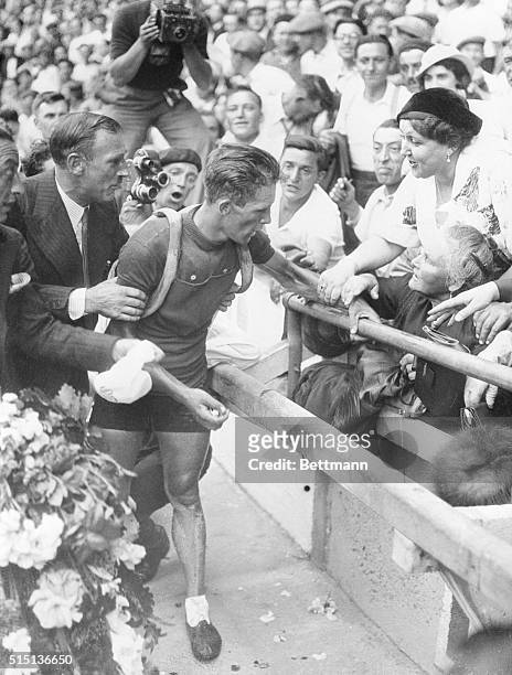 Editor's notes: Paris, July 27, 1935. Romain Maes is the Belgian winner of the 1935 "Tour de France". He was acclaimed by the audience as he entered...