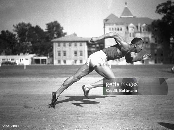 Jesse Owens, Ohio State's sensational athlete, is shown in the midst of running a sprint.