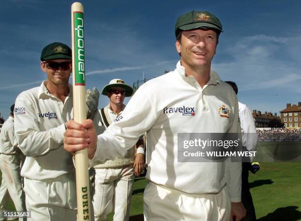 Victorious Australian captain Steve Waugh leads his team from the field with vice-captain Adam Gilchrist and Mark Waugh after defeating England on...